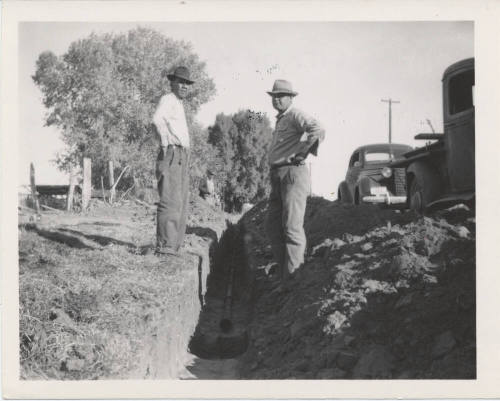 Three Workmen in Front of Trencher