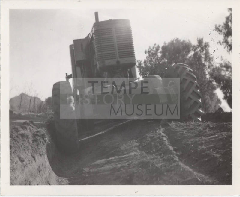 Rear View of City Road Grader at Trench