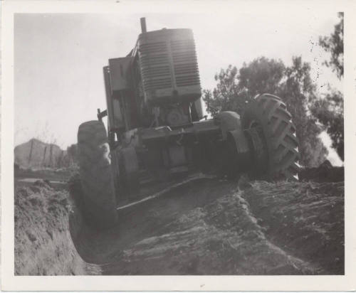 Rear View of City Road Grader at Trench