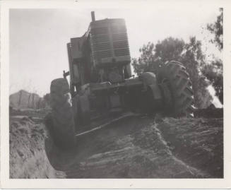 Rear View of City Road Grader at Trench
