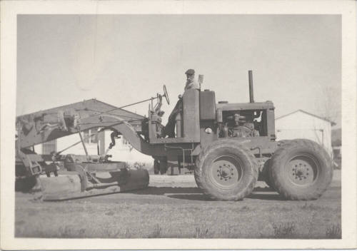 Man Standing on City Road Grader