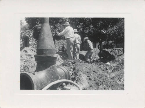Large Pipe and 3 Men at Construction Site