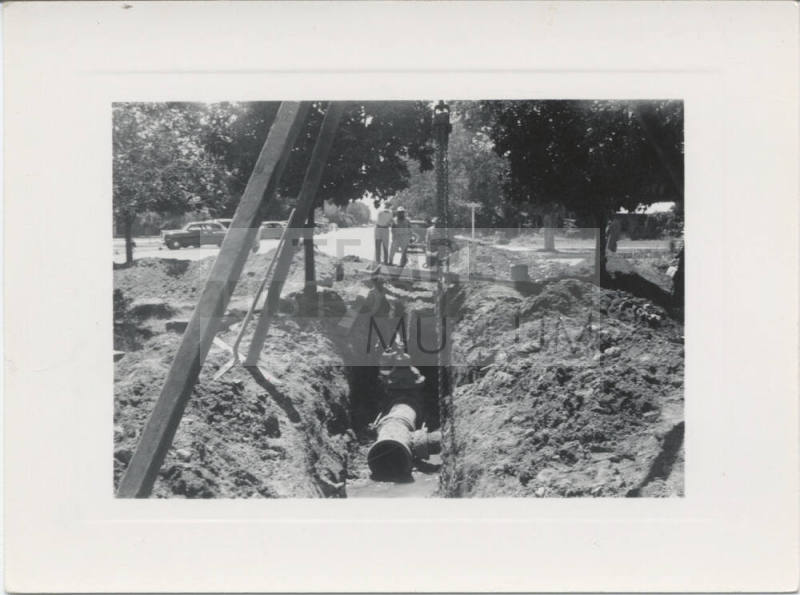 Four Men Inspecting Trench on College Av