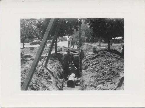 Four Men Inspecting Trench on College Av