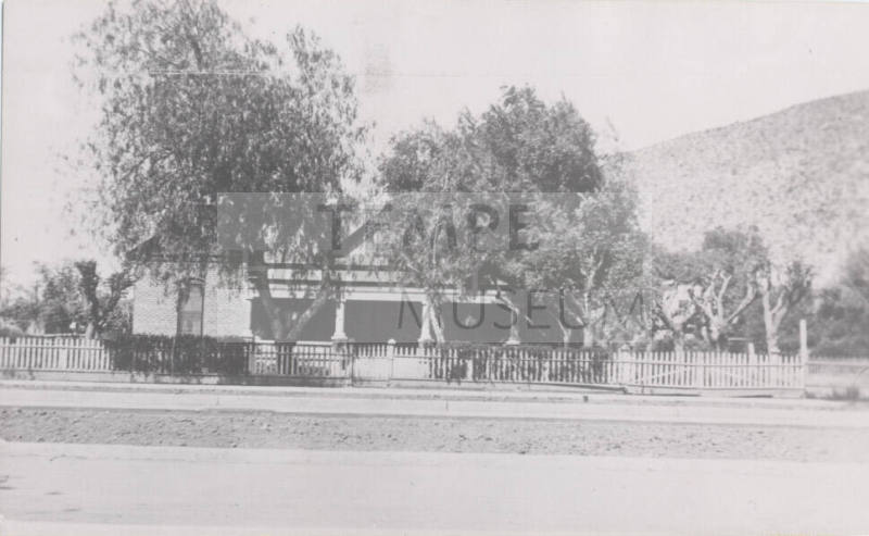 Photograph, house with butte in the background