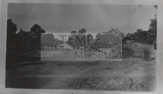 Dirt lot with paved road in background