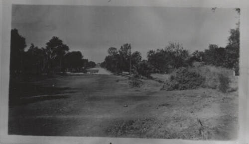 Dirt lot with paved road in background