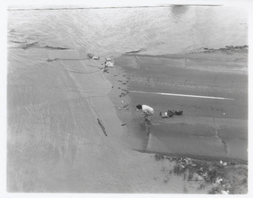 Road submerged by Salt River flood with person on road