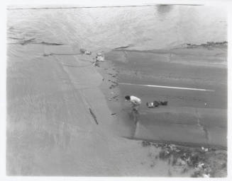Road submerged by Salt River flood with person on road