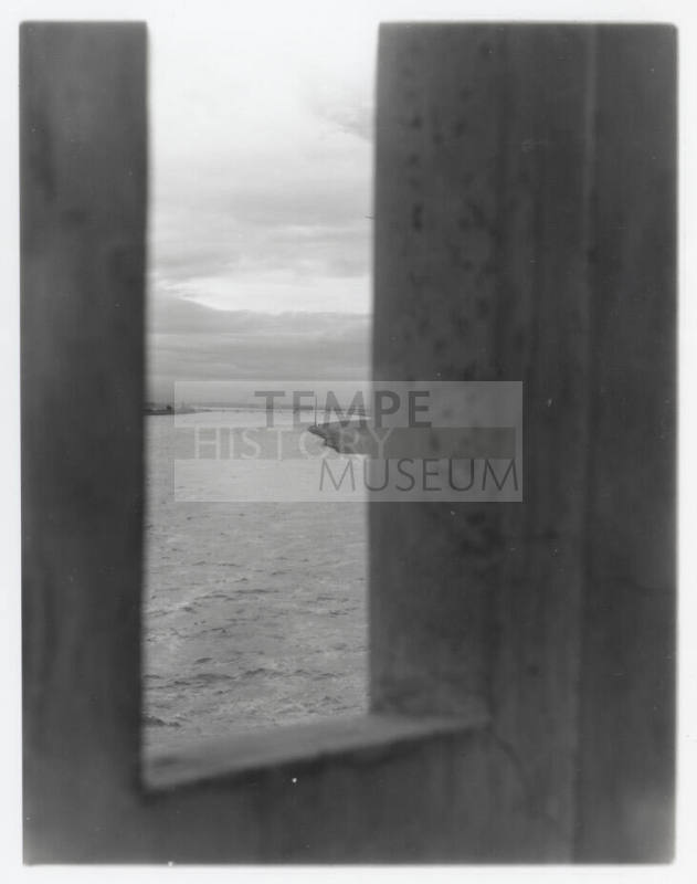 Vertical shot of river through opening in bridge (?)