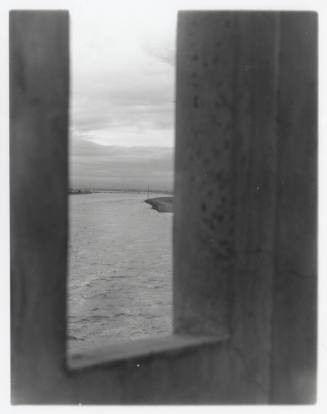 Vertical shot of river through opening in bridge (?)