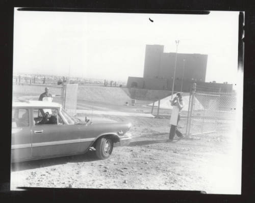 AFL-CIO organizers in front of a fence with a car