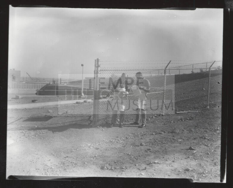 AFL-CIO union organizers with signs outside chain link fence