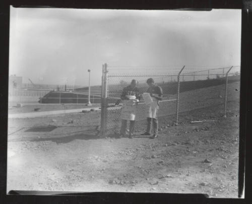 AFL-CIO union organizers with signs outside chain link fence