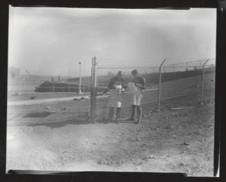 AFL-CIO union organizers with signs outside chain link fence