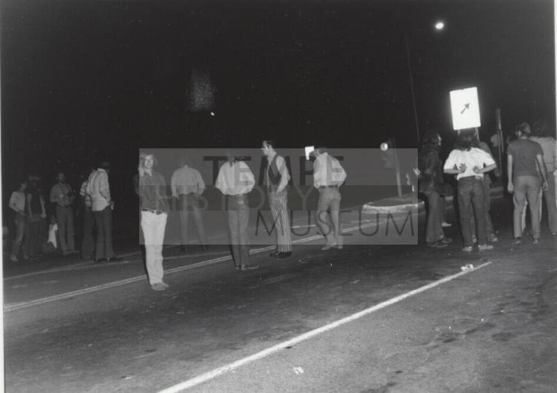 Demonstration march, 5-5-1971--Group of men standing in road backs to photographer