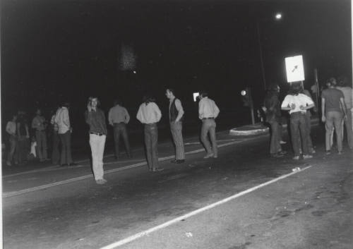 Demonstration march, 5-5-1971--Group of men standing in road backs to photographer