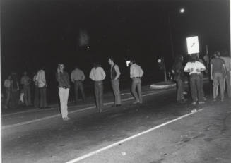 Demonstration march, 5-5-1971--Group of men standing in road backs to photographer