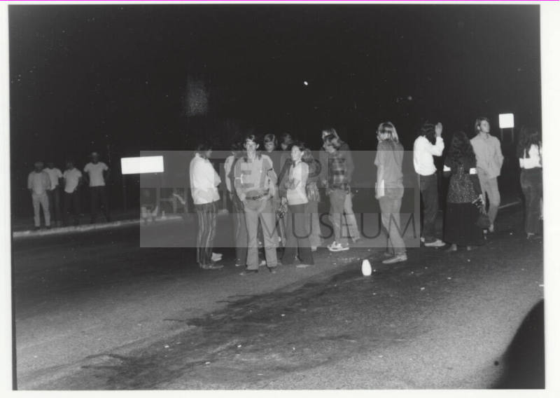 Demonstration march, 5-5-1971--Group of people some facing photographer, at night