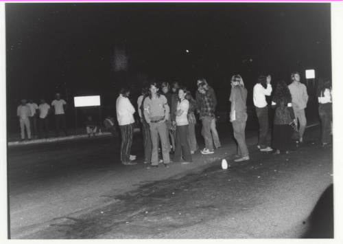 Demonstration march, 5-5-1971--Group of people some facing photographer, at night