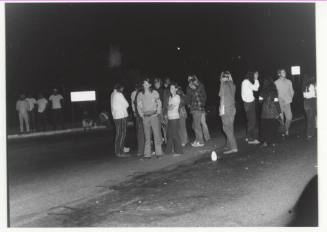 Demonstration march, 5-5-1971--Group of people some facing photographer, at night