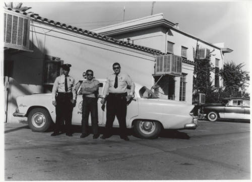 Two police officers and another man behind the Tempe Police station