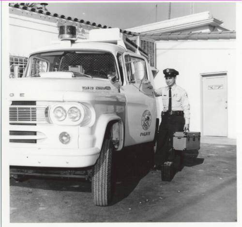 Police officer and vehicle behind the Tempe Police station