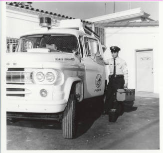 Police officer and vehicle behind the Tempe Police station