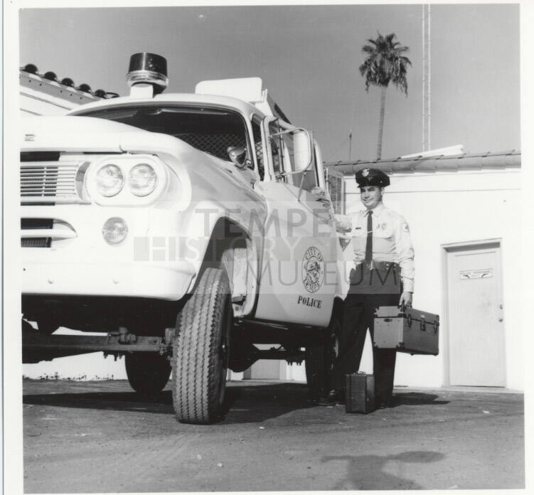 Police officer and vehicle behind the Tempe Police station