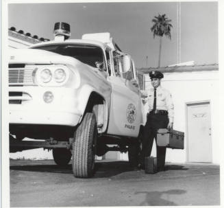 Police officer and vehicle behind the Tempe Police station