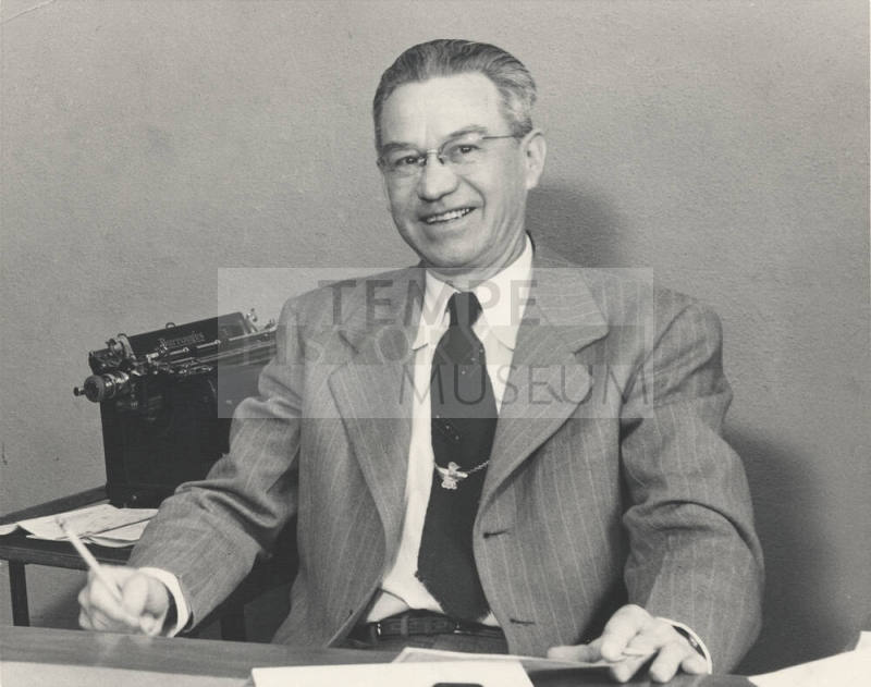 Photograph of Harvey Harelson at Desk