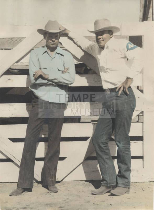 Colorized Photo of Larry and Frank Finley by a rodeo fence