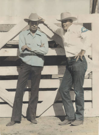 Colorized Photo of Larry and Frank Finley by a rodeo fence