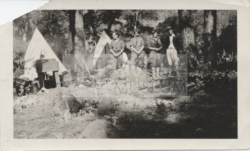 Four Campers with Tents and Camping Equipment