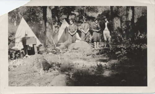 Four Campers with Tents and Camping Equipment