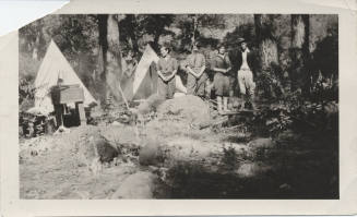 Four Campers with Tents and Camping Equipment