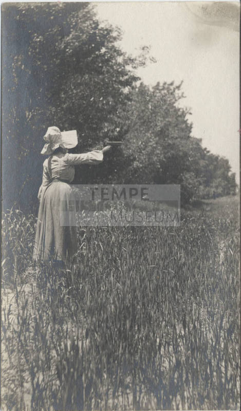 Woman Standing in Field Shooting Firearm