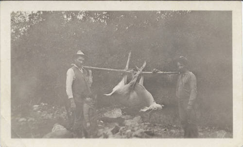 Two Hunters Carrying a Deer