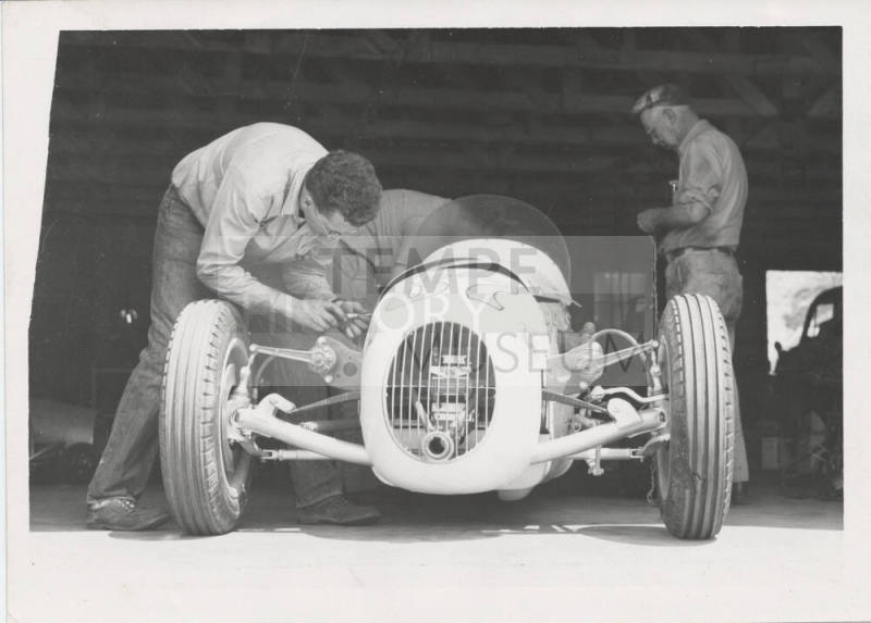 Three Mechanics with Racing Car