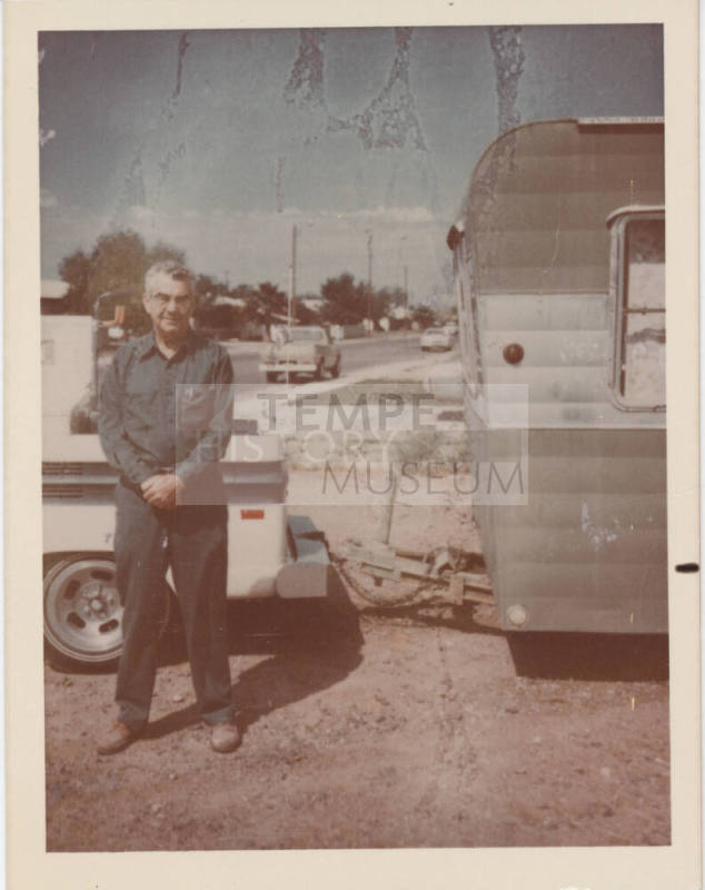 Man Standing Beside Truck with Trailer