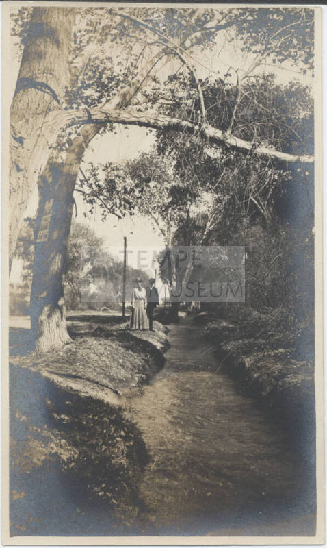 A Couple Walking Along Irrigation Canal