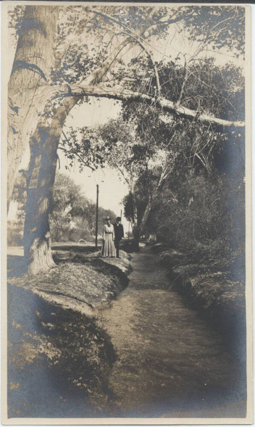 A Couple Walking Along Irrigation Canal
