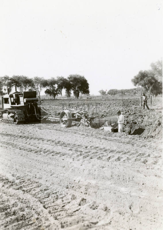 Tractor Ditching Field with Plow