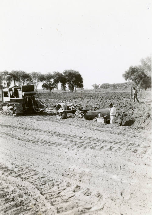 Tractor Ditching Field with Plow