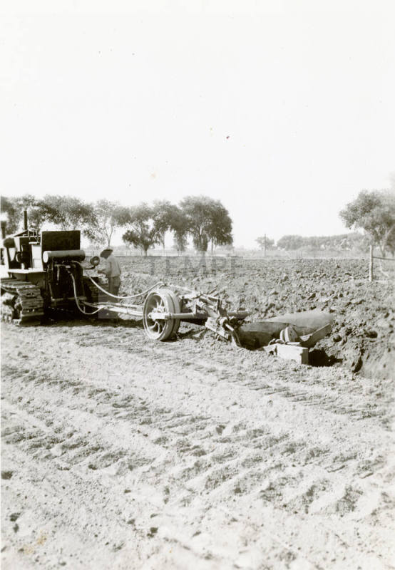 Tractor Ditching Field with Plow