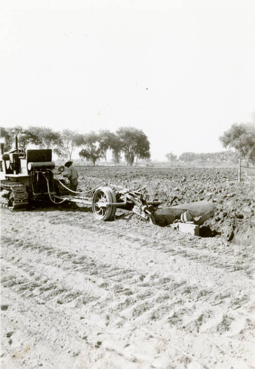 Tractor Ditching Field with Plow