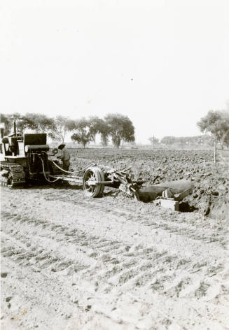 Tractor Ditching Field with Plow