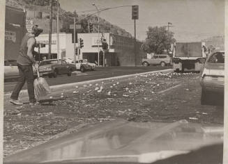 Man Cleaning Up Oranges-5th St and Mill