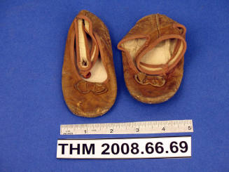 Pair of brown leather baby shoes with ankle straps