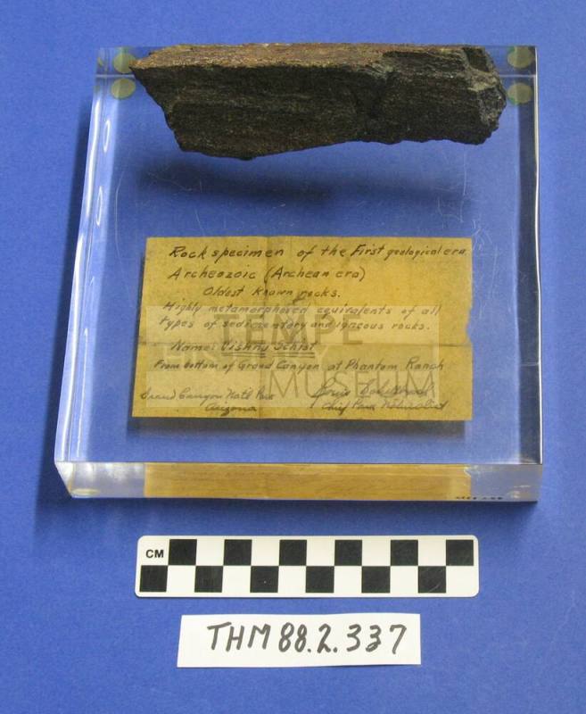 Rock specimen of the first geological era from Phantom Ranch Grand Canyon on a plastic base